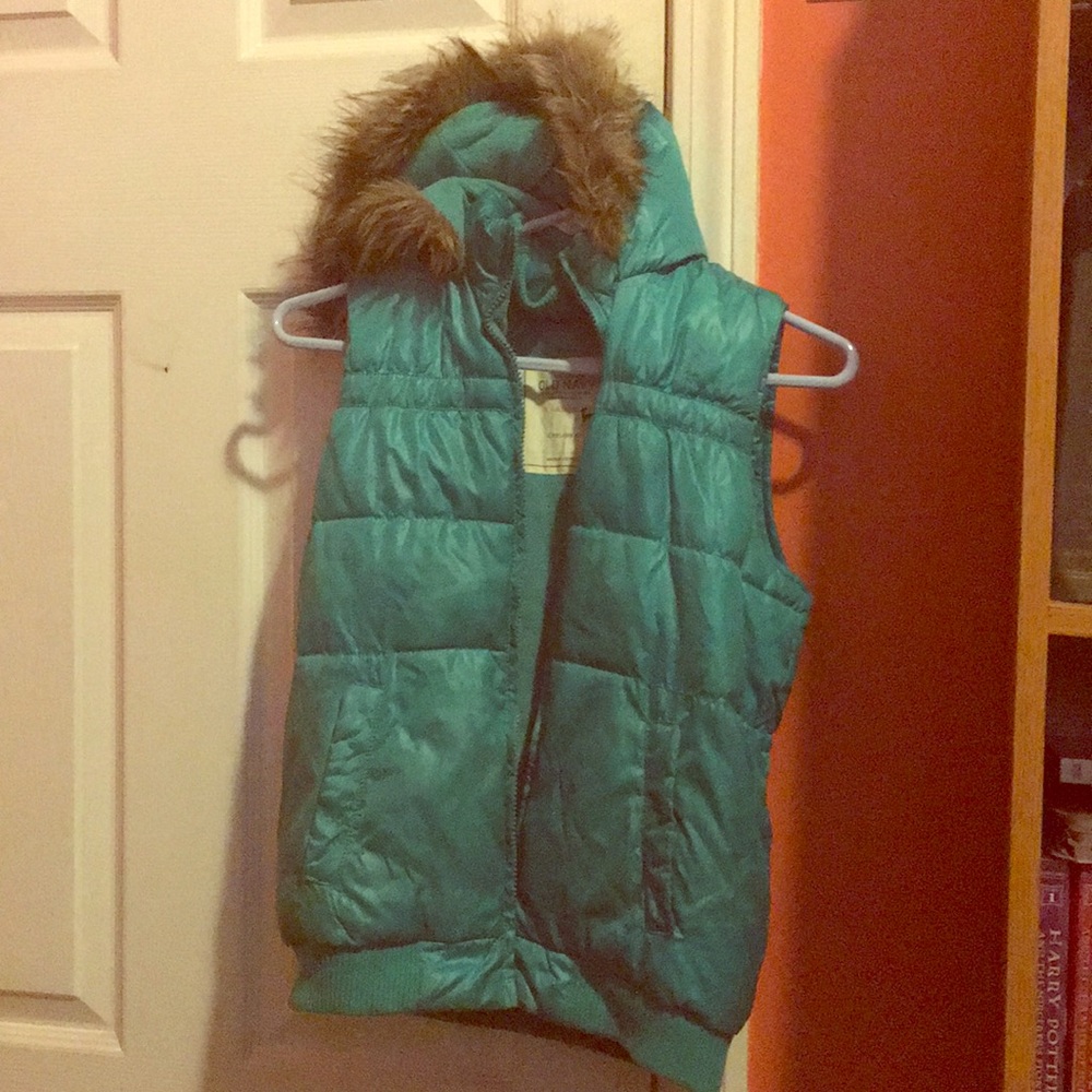 Green/blue vest with fur around the hood